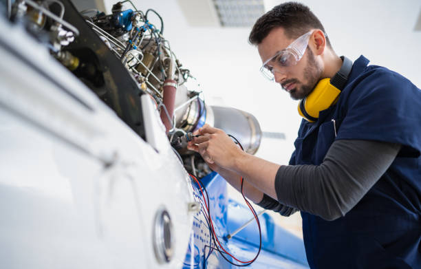 Aerospace technician performing quality inspection on aircraft engine components